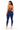 A woman modeling navy blue high-waisted leggings from the back, featuring a lace-up back design, on a solid white background.