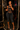 A woman posing in front of a mirror wearing a dark gray textured two-piece activewear set consisting of a strappy crop top and matching high-waisted cropped leggings.