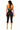 Back view of black halter lace capri romper featuring open back, tie neck detail, sheer floral lace, and bodycon silhouette.
