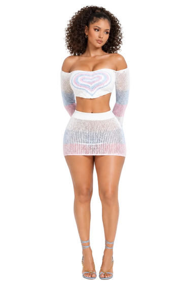 Woman wearing a colorful, sheer outfit on a white background