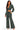A woman modeling a matching two-piece outfit consisting of a dark green acid-wash long-sleeve crop top and matching wide-leg drawstring pants, set against a plain white background.