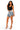 A woman modeling a black crop top and distressed light-wash denim shorts with frayed edges, paired with clear high-heel sandals, against a plain white background.
