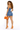 strapless denim short romper with orange handbag side pose